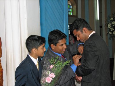 Fixing the flower on the groom's lapel