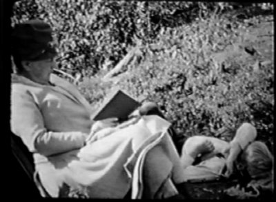 Family friend reading to Sam. (frame from 16mm film)