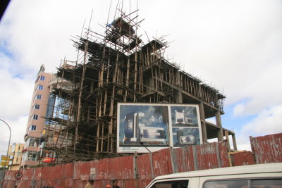 A new, seemingly high-tech building under construction using decidedly low-tech means.