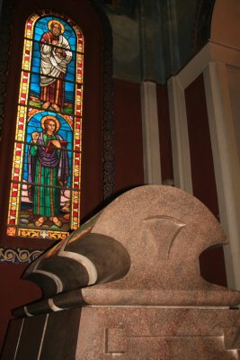 Haile Selassie's tomb, watched over by saints in the stained glass windows.  Note use of motif similar to Axum stelae as the top of the sarcophagus.