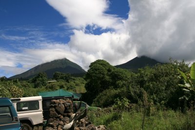 Mt. Muhabura and Mt. Gahinga from the entrance to Mgahinga Gorilla National Park.  Clouds move around the volcanic peaks constantly.