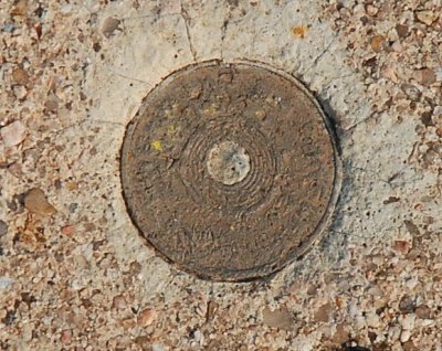 Mill Coin - embedded in Sidewalk Curb at Trinity Baptist Church