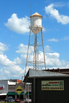 Pauls Valley's Landmark Watertower with Back of Johnson's Springcrest Draperies in Foreground