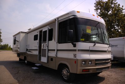 14-  35ft Winnebago Adventurer (color Sahara metallic) with master bedroom slide out