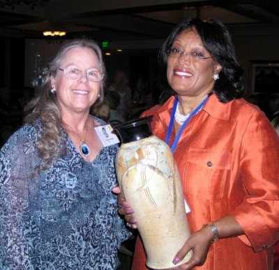 Connie's ceramic is given to Sonja Larkin