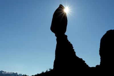 Sun peaking over the Balanced Rock, Arches National Park