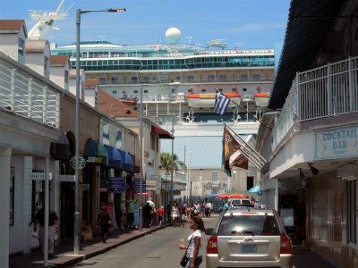 Cruise ship towering over the waterfront shops