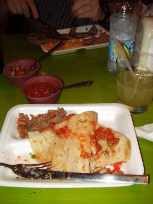 Lobster quesodillas and steak, served on styrofoam plates.