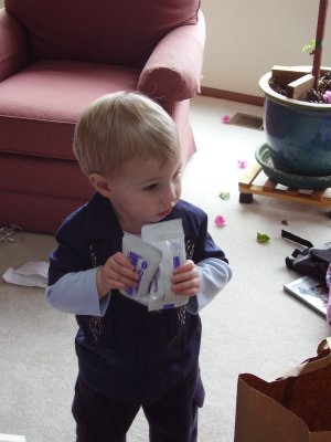 Tate with several packages of weird purple playdoh.