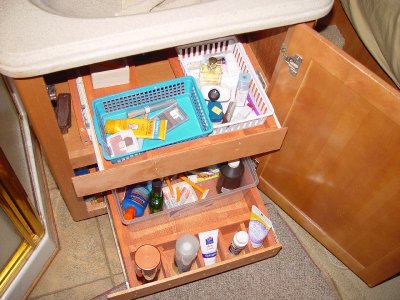 WE EACH HAVE ARE OWN DRAWER THAT SLIDES OUT BELOW THE SINK WITH CUSTOM SLOTS