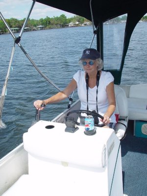 SARA TOOK HER TURN AT THE HELM AS CHARLIE AND I WATCHED FOR MANATEES FROM THE FRONT OF THE BOAT