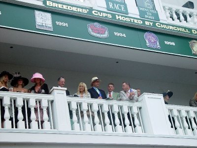VIEW OF THE FOLKS IN THE RICH SEATS LOOKING OVER THE PADDOCK