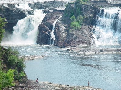 THE WATER WAS RUSHING OVER THE FALLS