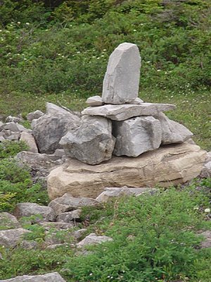 THESE STONE MARKERS ARE CALLED CAIRNS AND WERE BUILT BY LOCALS TO FIND A SPOT OR ROUTE