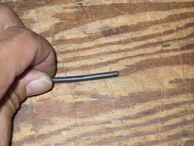 Take your utility knife and score all around the outer jacket of the cable.  Not too deep; just make a line like this.