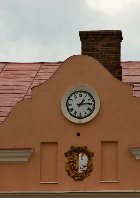 Clock Between Crest And Chimney