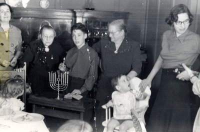 Lighting Chanuka Candles with Grandmothers Goldberg and Rosenberg - Chanuka 1951.jpg