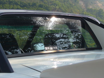Toyota printed on rear glass, through the rear sun Visor