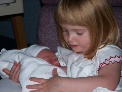 Sophie holding her long awaited brother