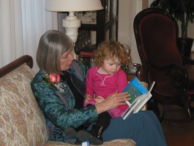 Bonnie reads one of the new books to little helper Sadie.