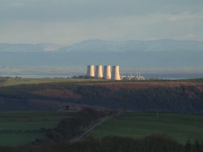 Late afternoon sunlight illuminates the cooling towers at Chapelcross.