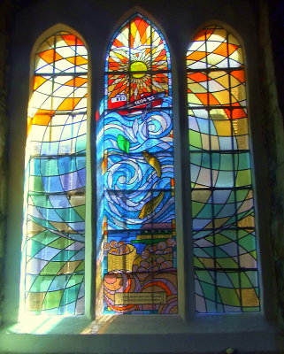 Stained glass window dedicated to local oystermen and cocklers.
