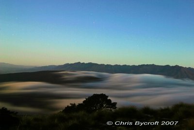 Slow exposure of night light, fog, and Takitmu Range