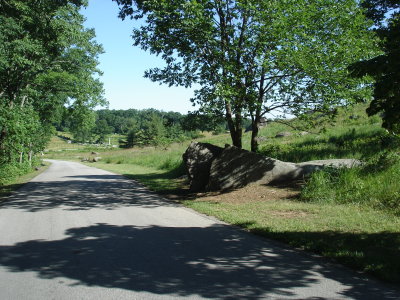 The Texan's and Alabama boys charged from left to right up Little Round Top