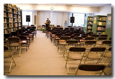 3. Audience seating is arranged in the stacks of the library.