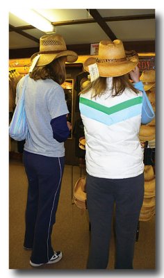 Cowgirls try on hats at the Trading Post.