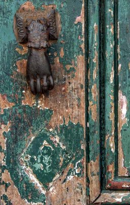 The green door with the hand and ring