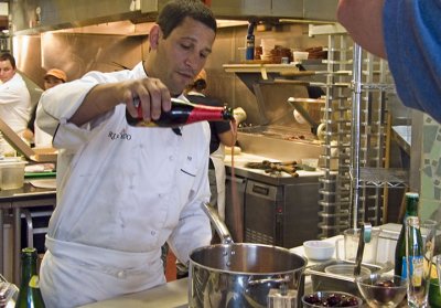 To his pot of boiling chopped cherries and other recipe ingredients, Morales adds a bottle of kriek lambic, a Belgian fruit ale.