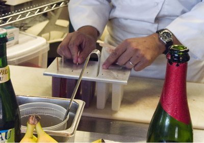 Chef Morales inserts the hopsicle sticks into the mold.