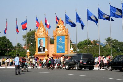 Flags in downtown Phnom Penh with a billboard of King Norodom Sihanouk who abdicated the throne to his son in 2004.