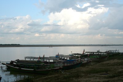 A ferry boat and Ayeyarwaddy River view with wispy clouds overhead.