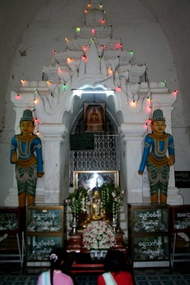 Interior statues in the Thatbyinnyu Temple with colored lights.