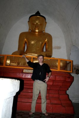 Me standing in front of the large seated Buddha inside the Thatbyinnyu Temple.