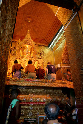 View of me and others applying gold leaf and revering the Buddha.