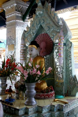 A Buddha image and flowers at the Kuthodaw Pagoda.