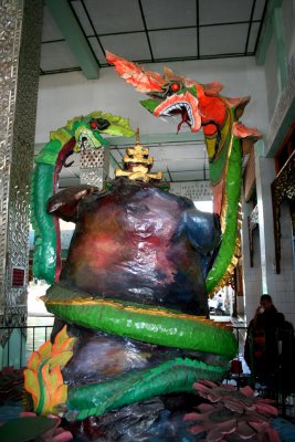 Naga king Nandopananda on left, on right, Buddha's disciple Moggalana, who turns into a bigger naga to subdue the naga king.