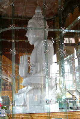 Sideview of the Buddha with light reflecting off of the plexiglass.