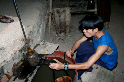 He is making glass which is blown into a mold.