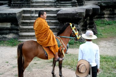 Closeup of the monk on horseback.