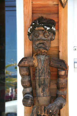 One of two macabre looking statues (with a bandana) standing at the door of the shop.