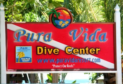 Sign for Pura Vida (Pure Life) Dive Center.  Diving is the main attraction of Roatn.
