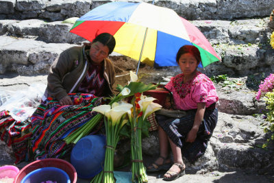 A woman and young girl selling flowers. The woman was nodding off.