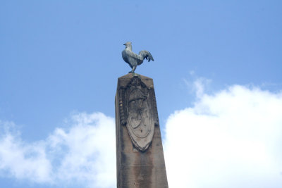 On top of the monument is a rooster.