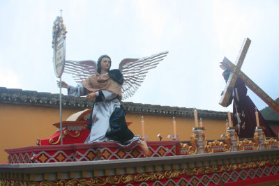 This float depicts an angel and Christ carrying the cross.