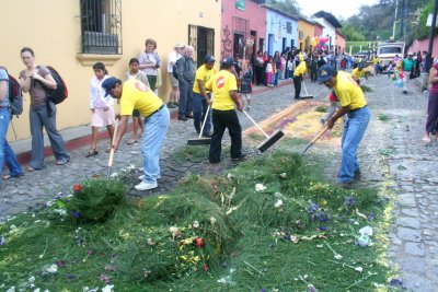 The cleanup crew stepped in to clean up the huge mess that remained of the carpets after the procession.
