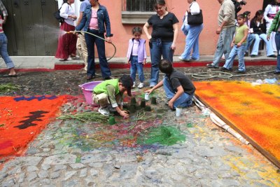 These Guatemalan kids were using cups to make shapes with sawdust.